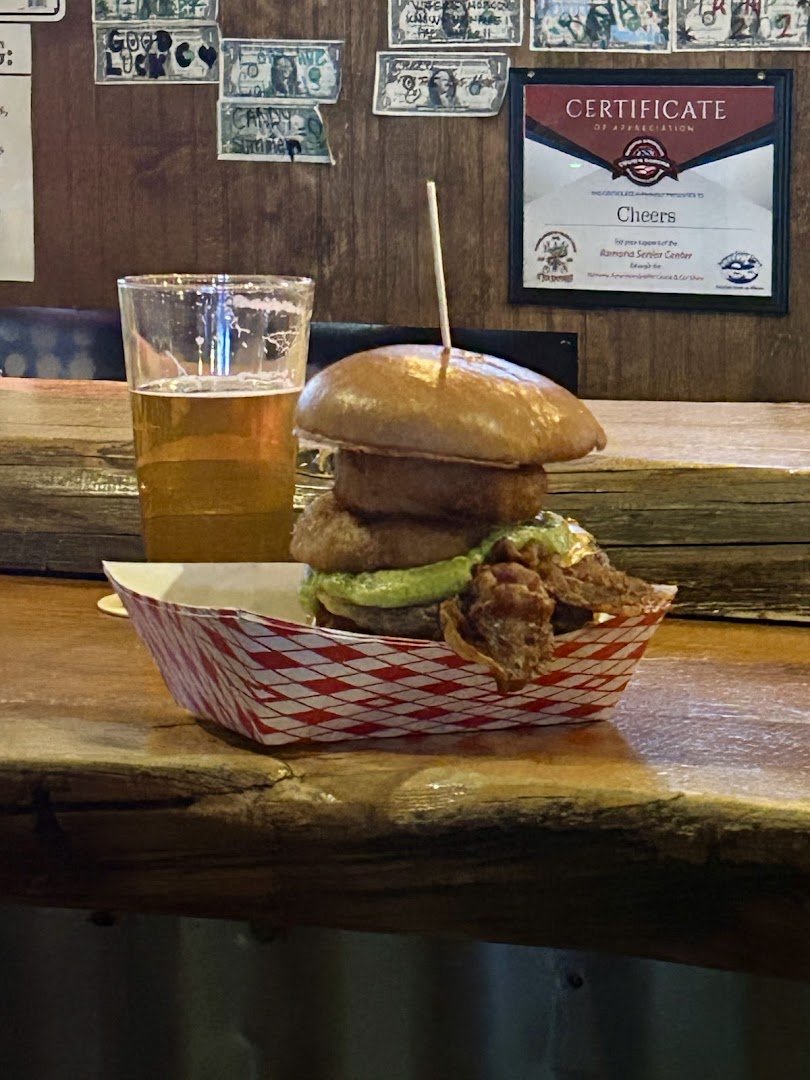 Warm lighting over burgers and beer glasses.