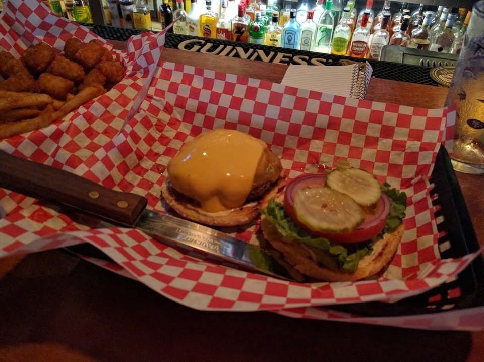 Printed menu listing burgers and sandwich-style items.